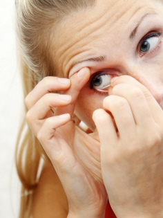 girl taking out contact lens